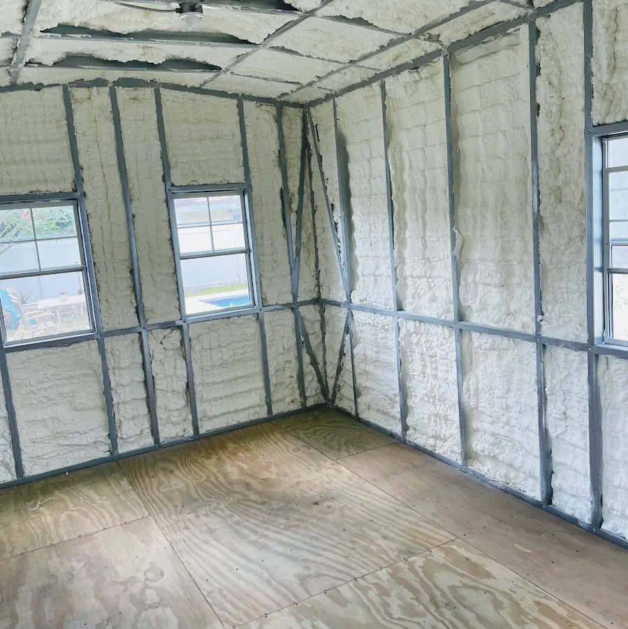 Closed-cell spray foam insulation applied to wall cavities in a residential project in Mitchell